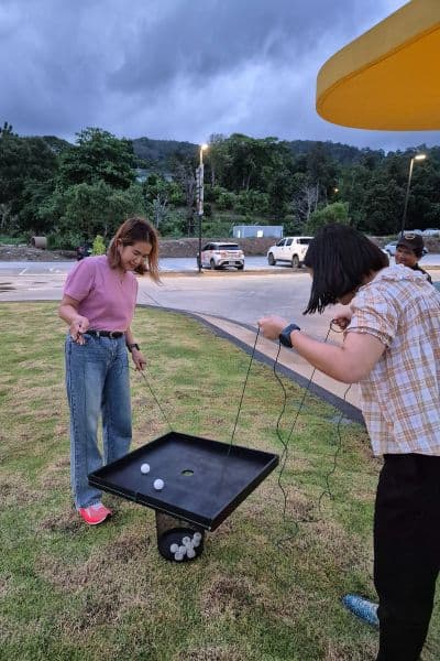 People playing an outdoor team coordination game.