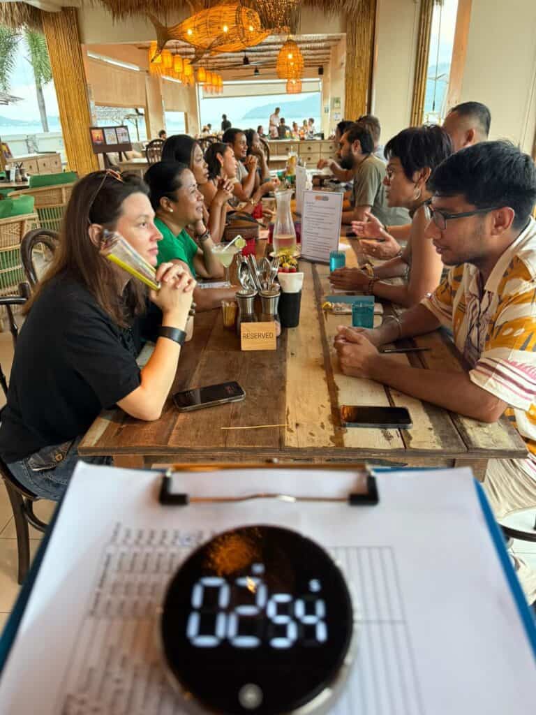 Group speed dating event at coastal restaurant.