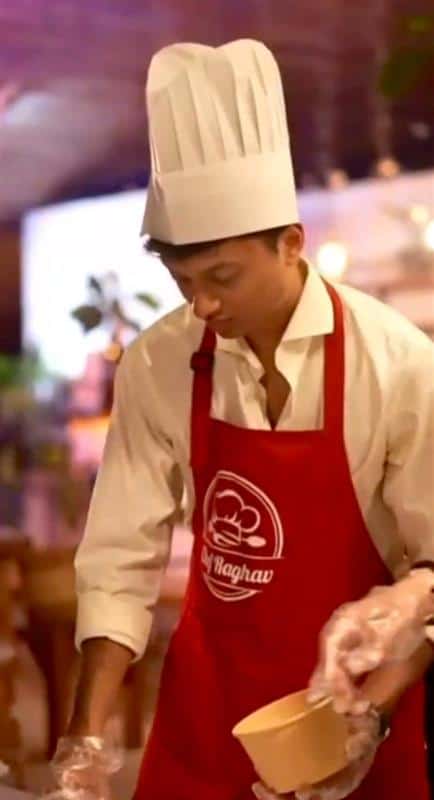 Chef preparing food in a kitchen.